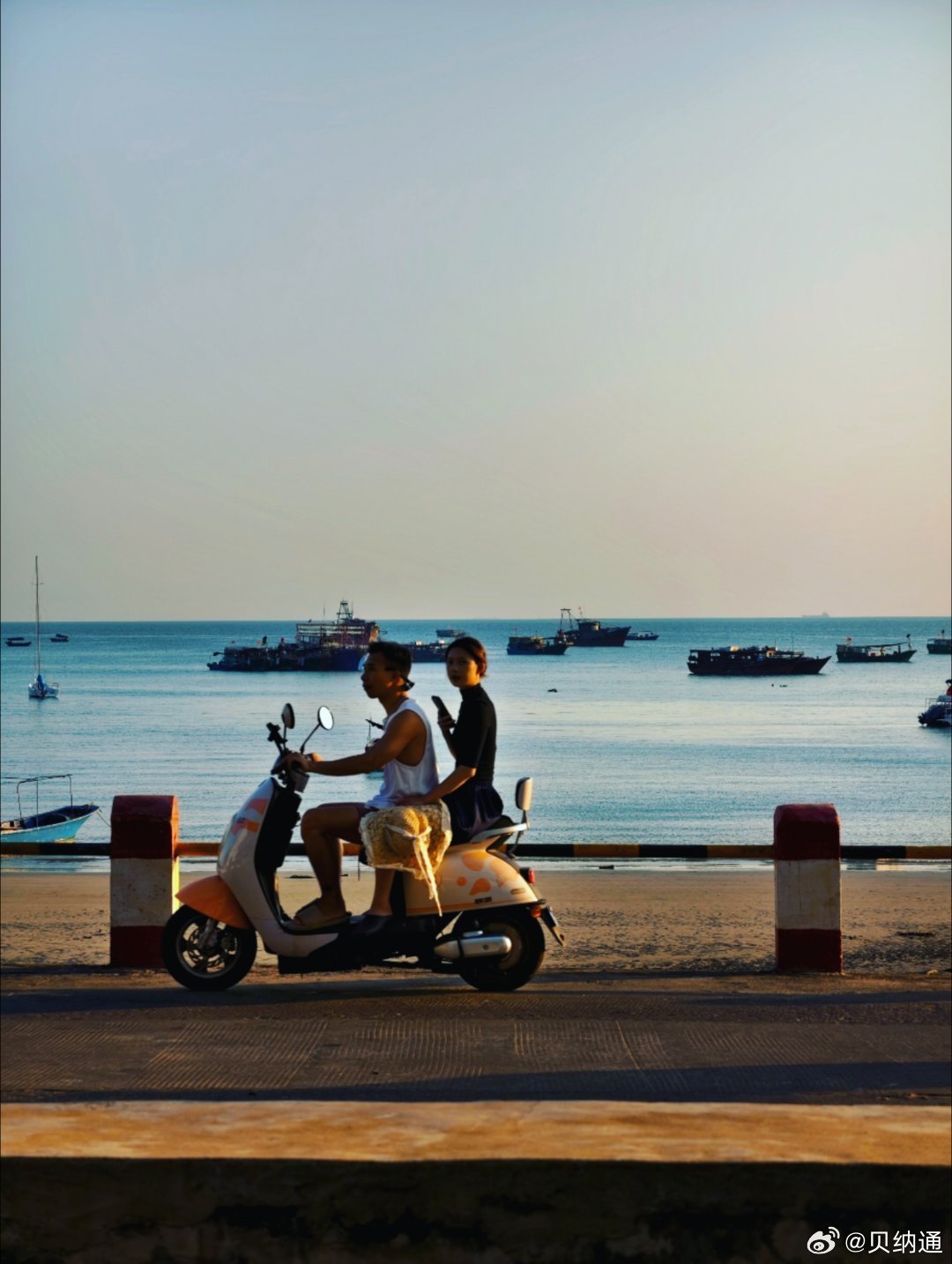 A couple riding a scooter along the coast, capturing the island’s relaxed and adventurous spirit