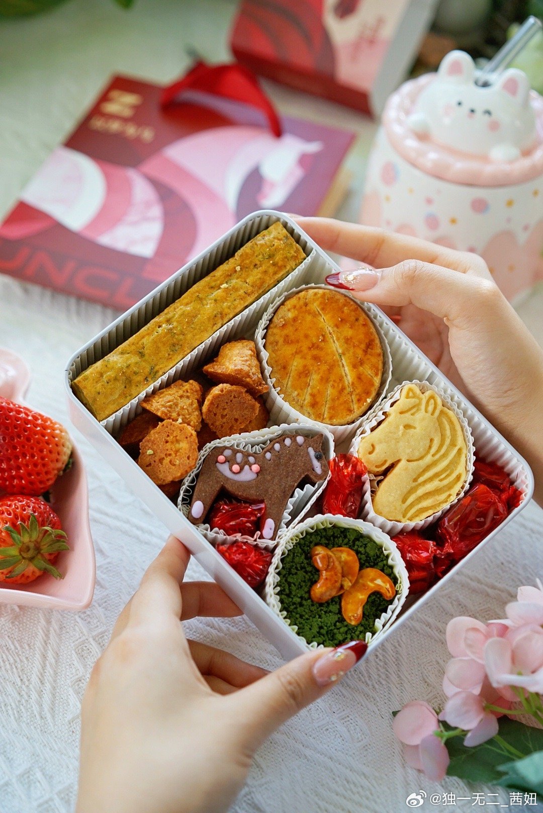 A box of handmade pastries featuring horse-shaped cookies and other treats, symbolizing the Year of the Horse.